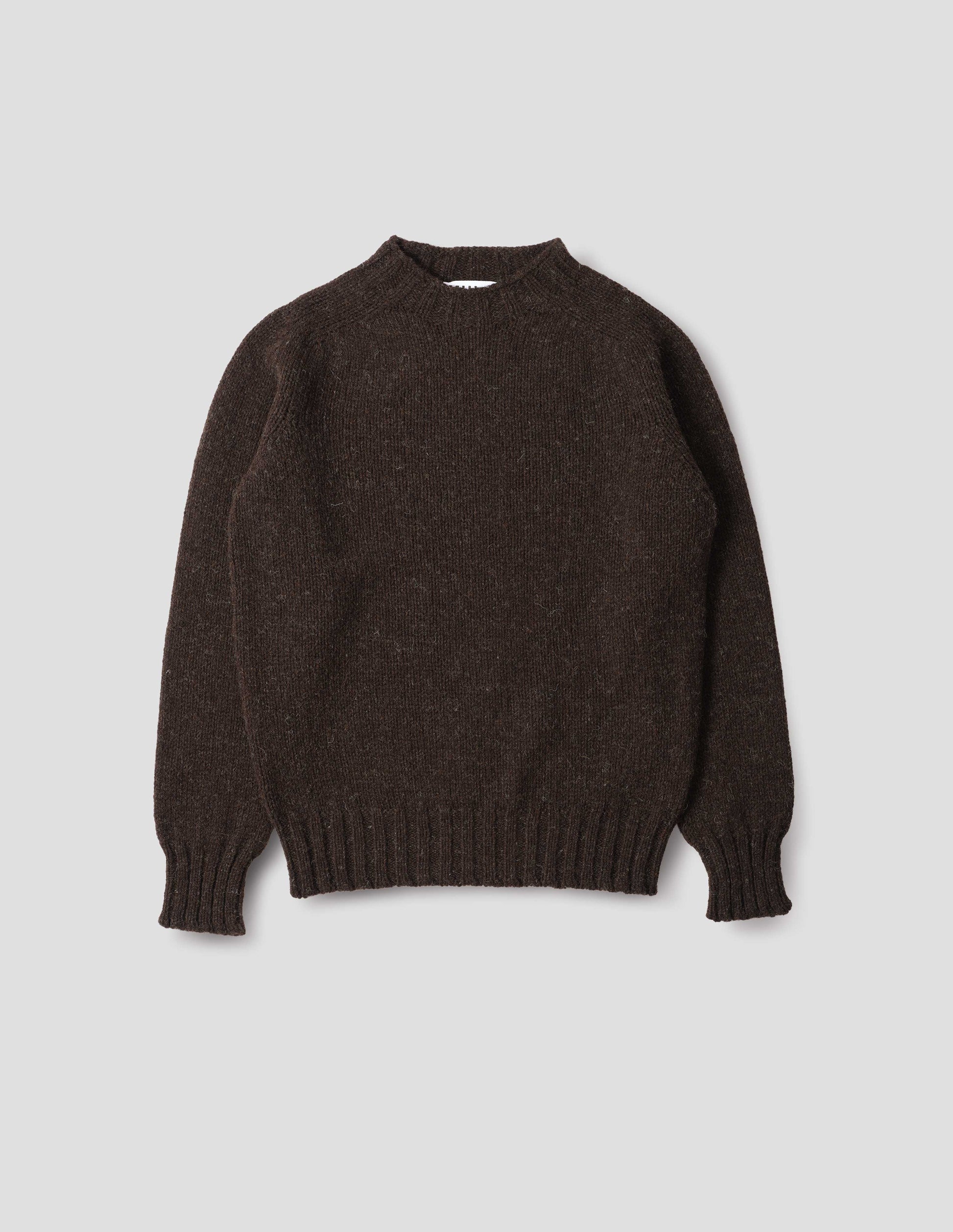 Dark brown marl jumper with saddle sleeves and contrasting rib on neck, cuffs and hem. Front flat lay view. 