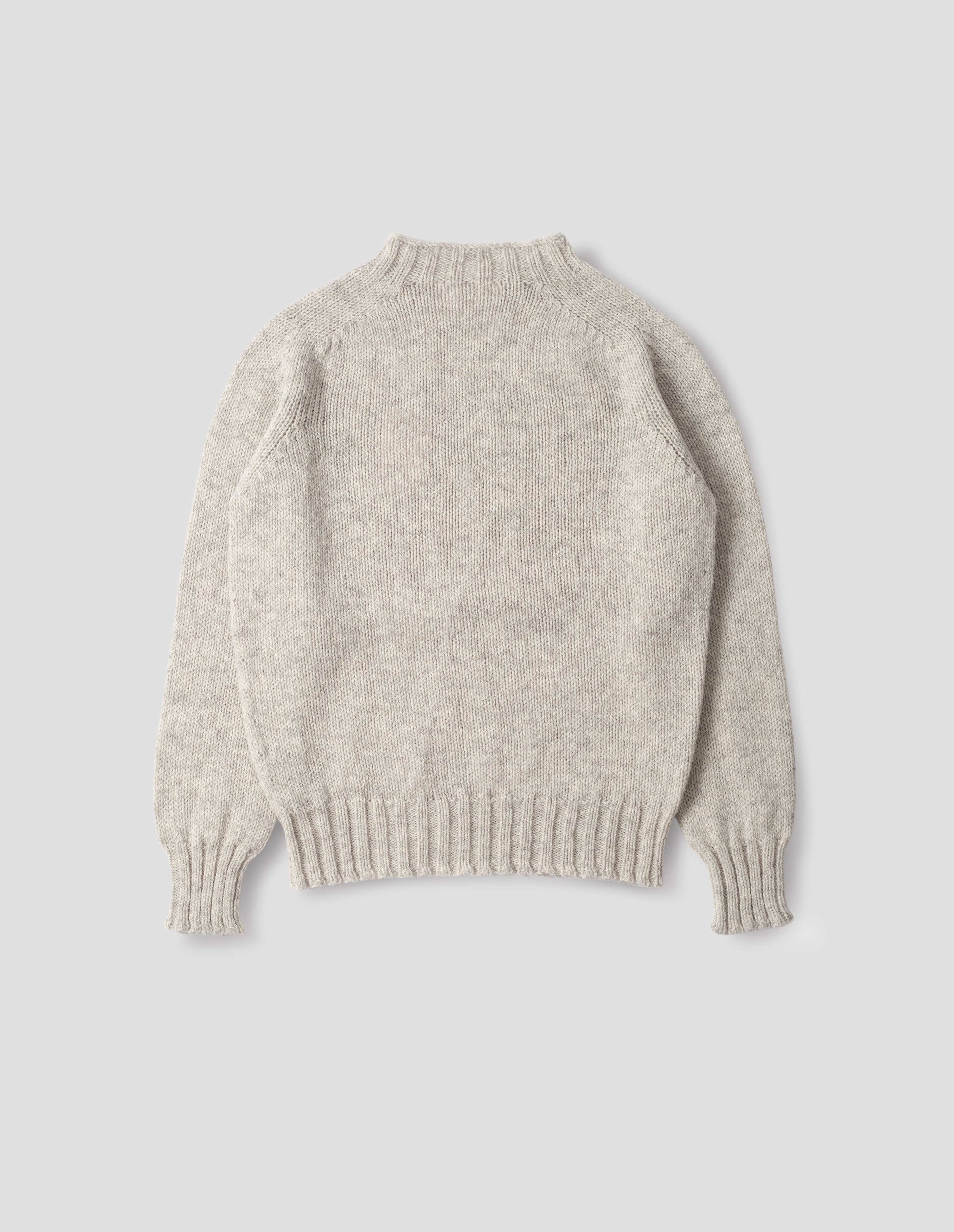 Beige marl jumper with saddle sleeves and contrasting rib on neck, cuffs and hem. Back flat lay view. 