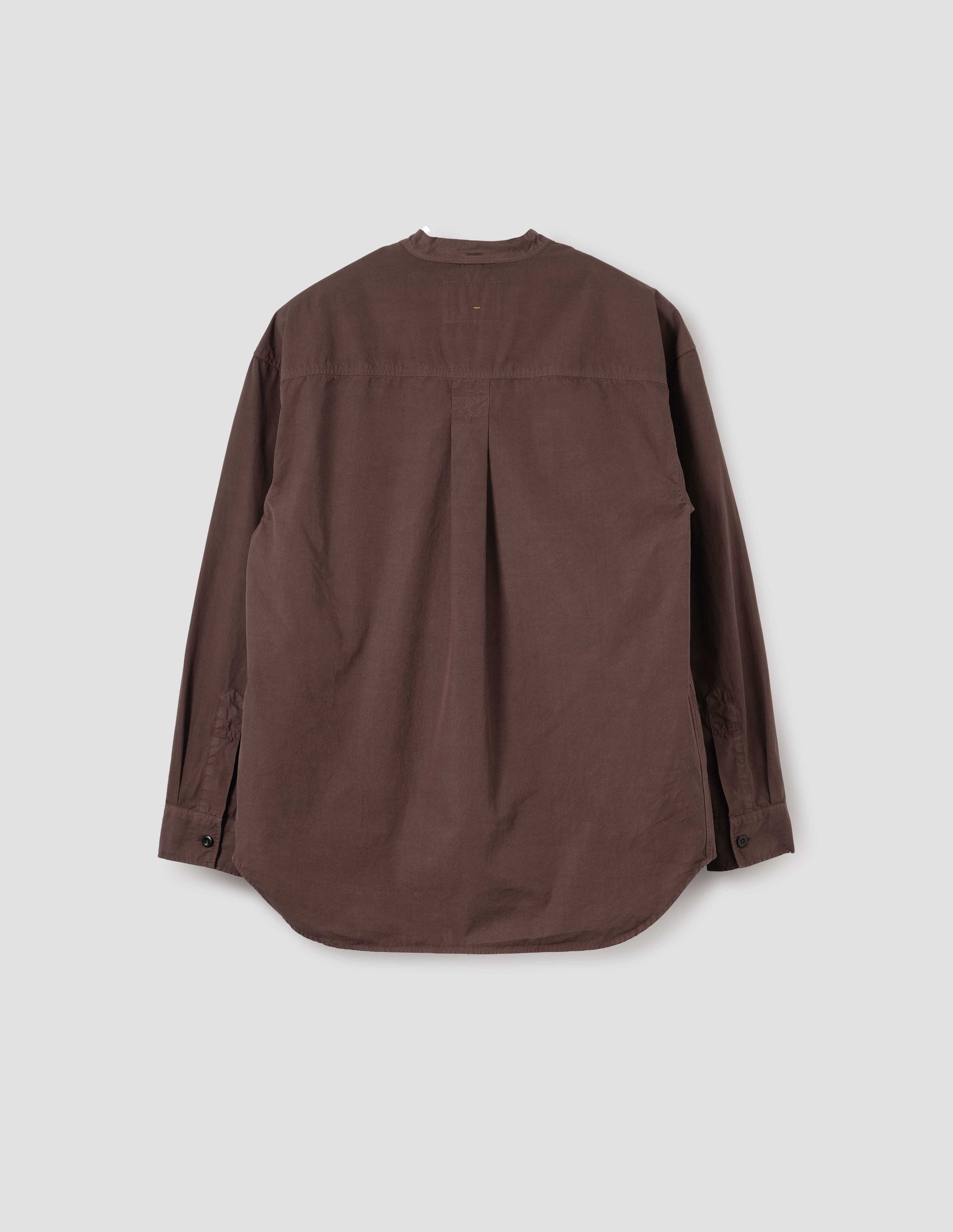Brownish red cotton collarless shirt, with curved side gusset, box pleat on back yoke and corozo brace button cuffs. Back flat lay view.