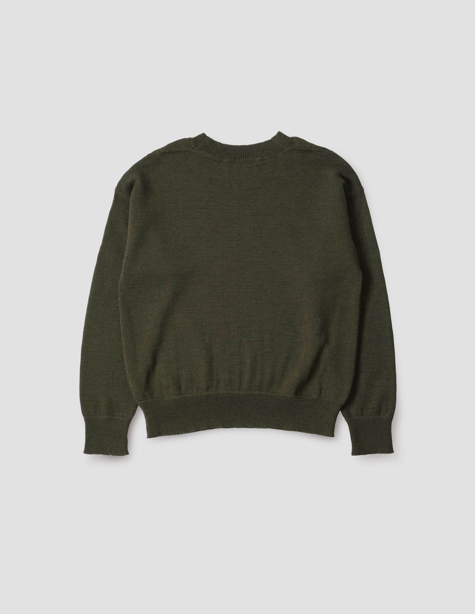 Green wool jumper, with contrasting rib on neck, cuffs and hem, flatlock stitching detailing on seams and t shape shoulder seams. Back flat lay view.