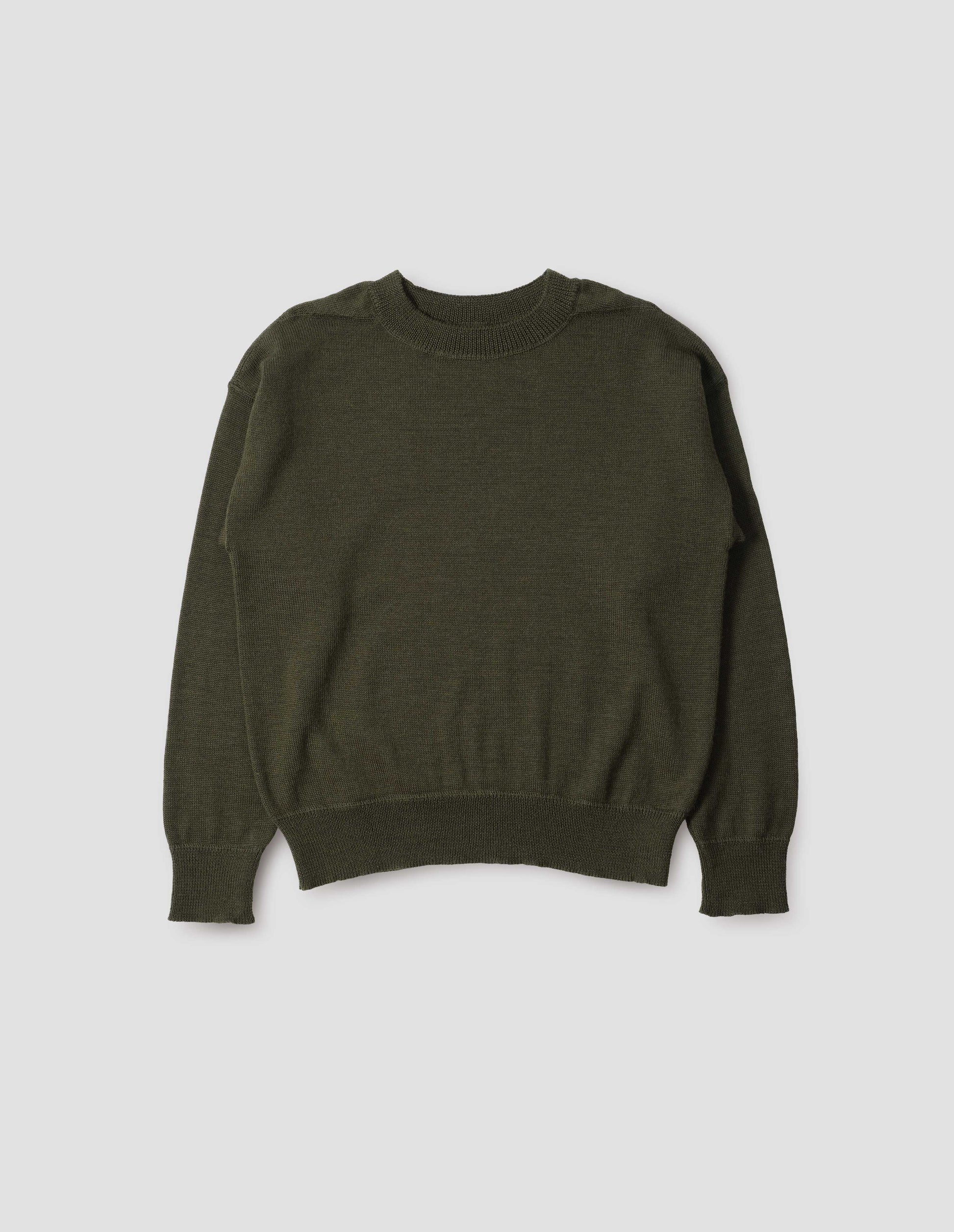 Green wool jumper, with contrasting rib on neck, cuffs and hem and flatlock stitching detailing on seams. Front flat lay view.