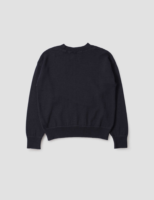 Dark navy wool jumper, with contrasting rib on neck, cuffs and hem, flatlock stitching detailing on seams and t shape shoulder seams. Back flat lay view.