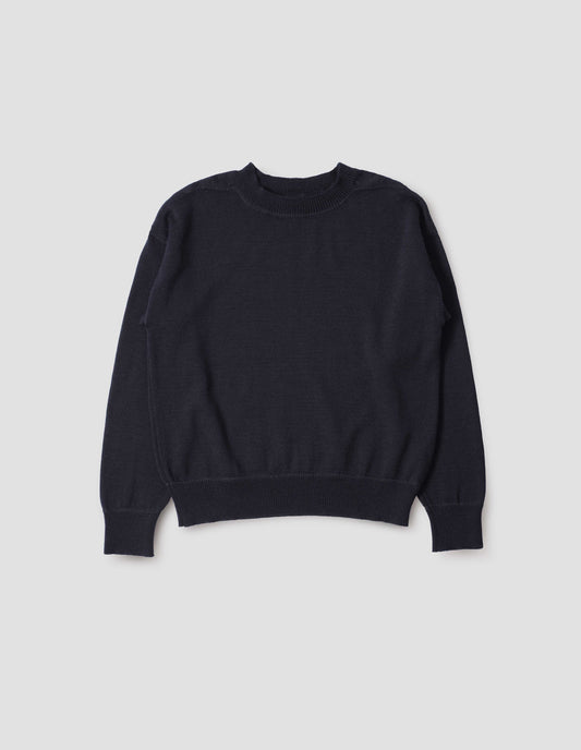Dark navy wool jumper, with contrasting rib on neck, cuffs and hem and flatlock stitching detailing on seams. Front flat lay view.