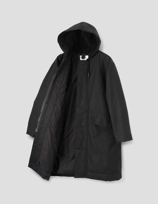 Black hooded parka with fleece lined drawcord hood, two way zip fastening with button fastening storm flap and slanted flap pockets. Front flat lay open view.