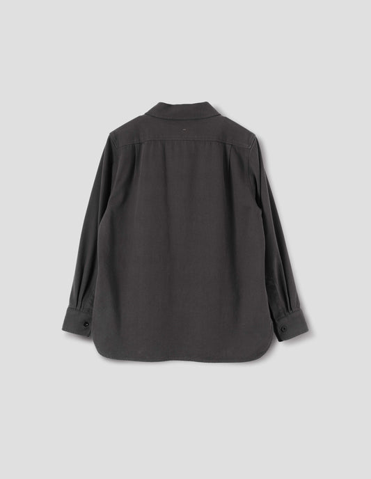 Grey overhead shirt with corozo button closure cuffs and elongated back hem. Back flat lay view.