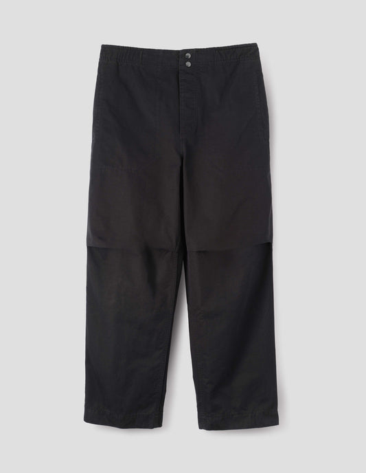 Black trousers with slant welt pockets, corozo brace button fly and press stud hem adjusters. Front flat lay view.