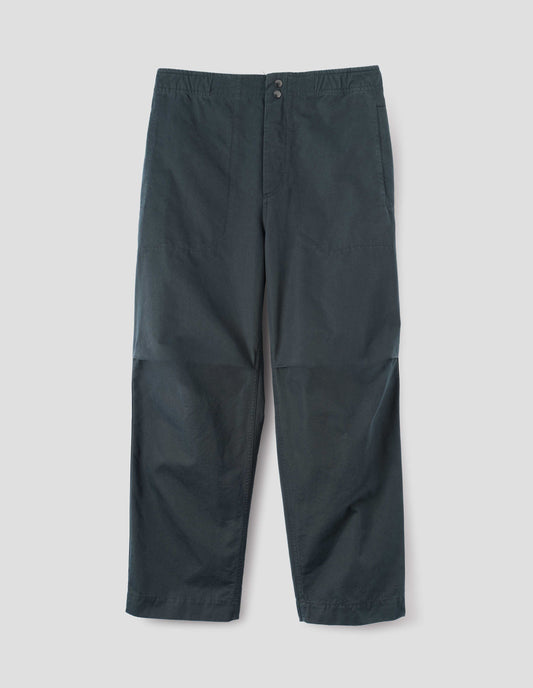 Blue trousers with slant welt pockets, corozo brace button fly and press stud hem adjusters. Front flay lay view.