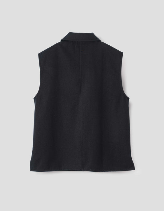 Black sleeveless wool cotton drill overshirt with stitch through facing and vent split hem. Back flat lay view.