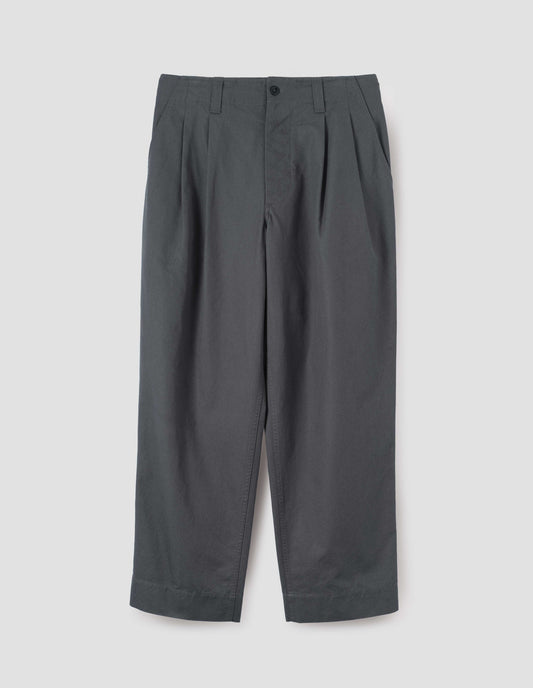 Charcoal grey heavy cotton trousers, with double pleats, slant pockets, corozo button and zip fastening and belt loops, front flat lay view.
