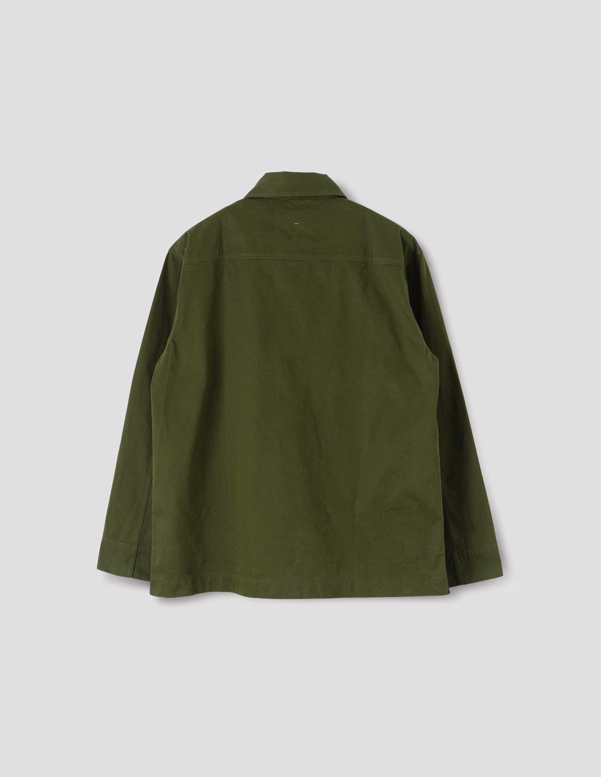 Green shirt with straight cuffs and vent split hem with herringbone tape detailing. Back flat lay view.