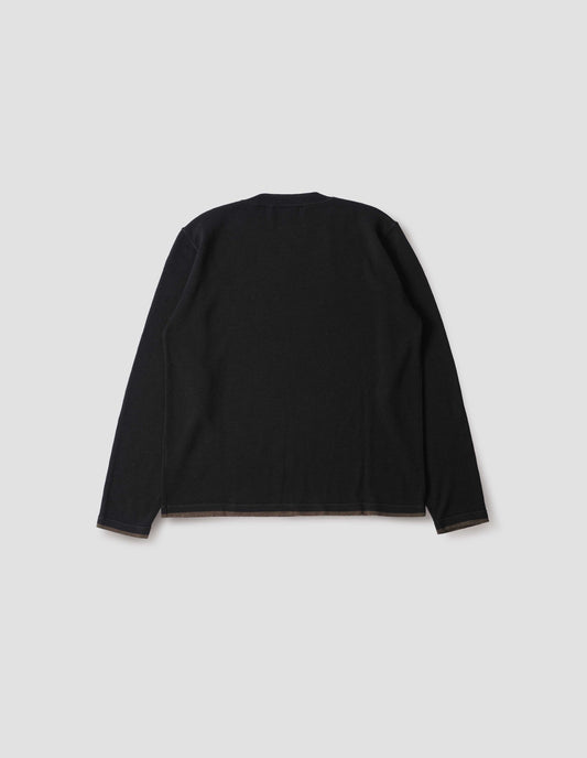 Black long sleeve knitted thermal with ribbed collar, khaki green stripe on cuffs and hem, back flat lay view.
