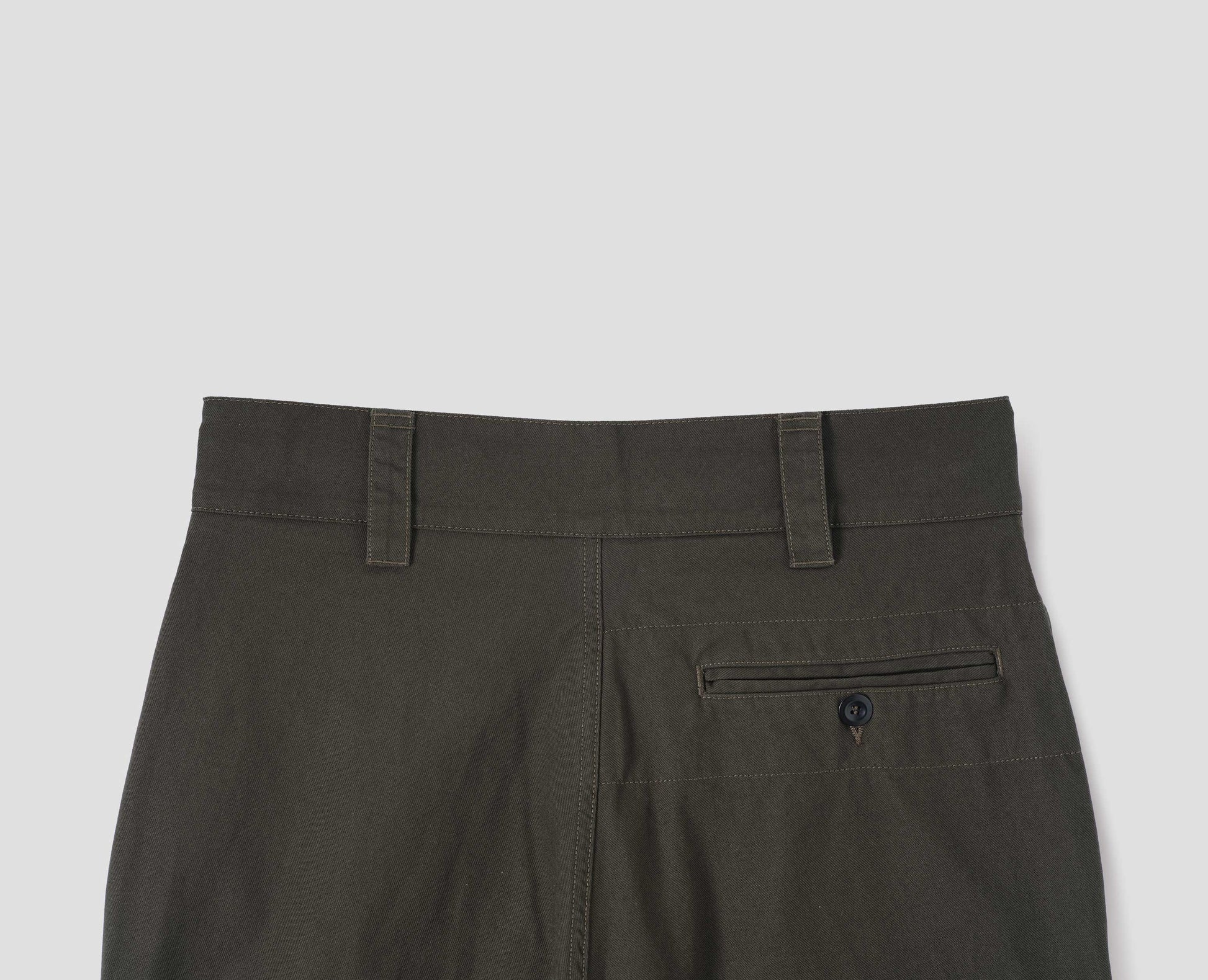 Green brown trousers with button closure welt pocket, and belt loops. Back flat lay view.