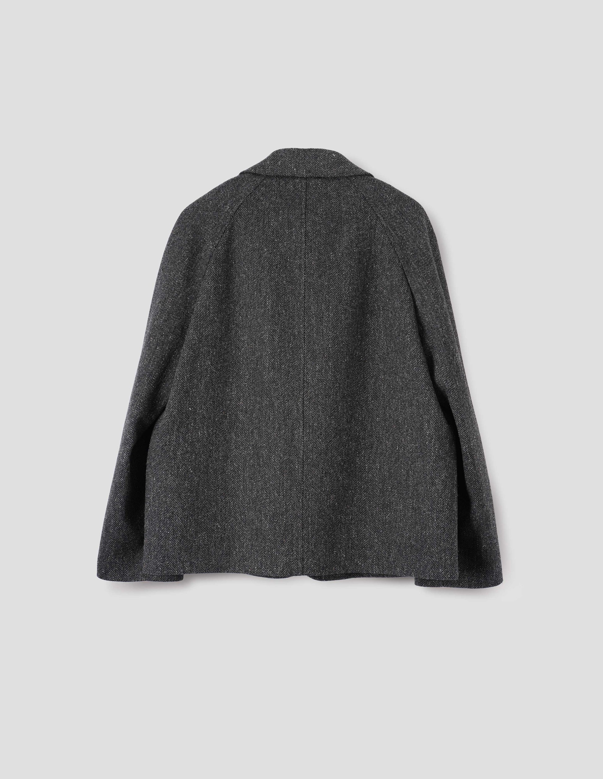 Grey wool blazer with high collar fastening and raglan sleeve. Back flat lay view. 