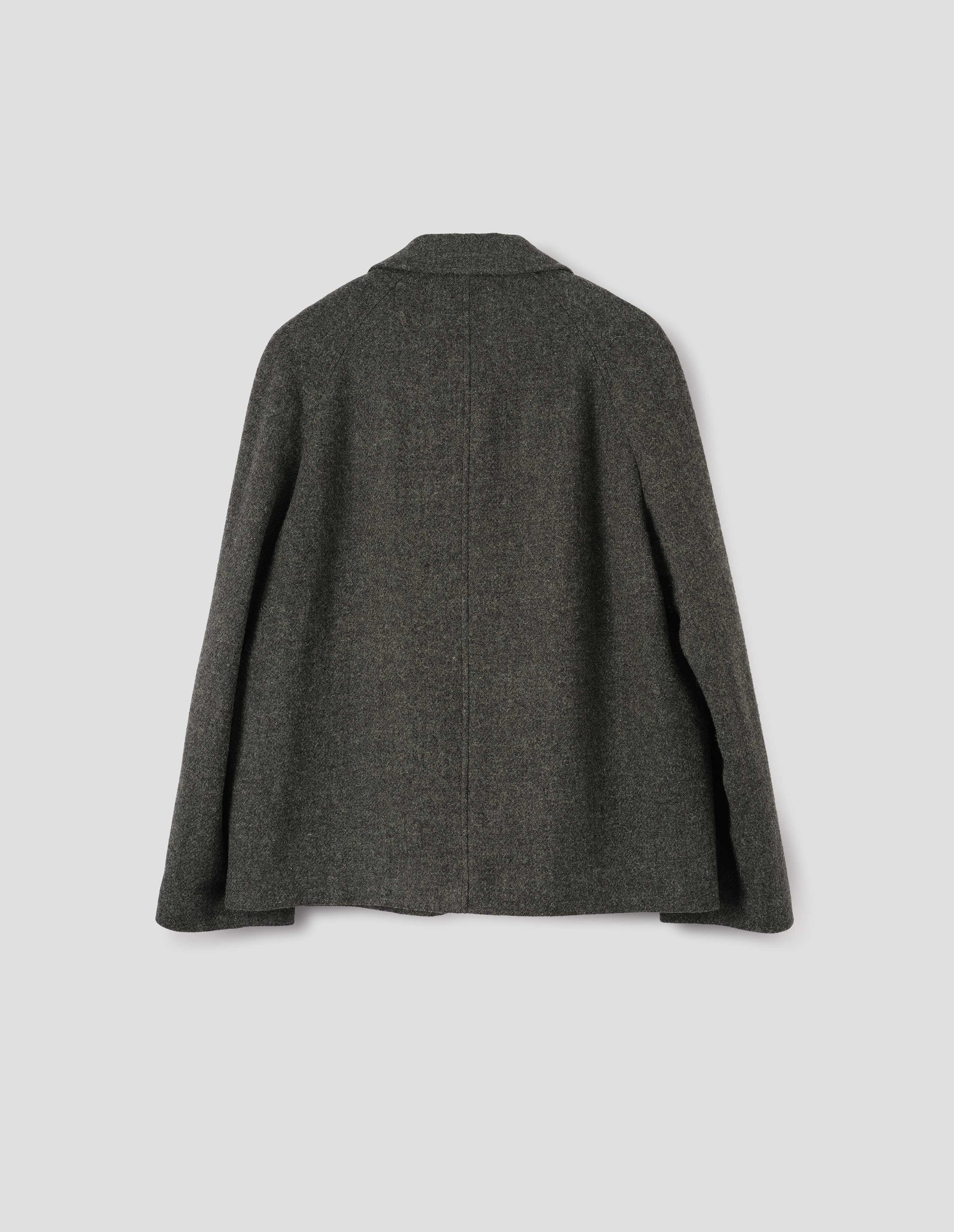 Dark grey harris tweed wool blazer with high collar fastening and raglan sleeve. Back flat lay view. 