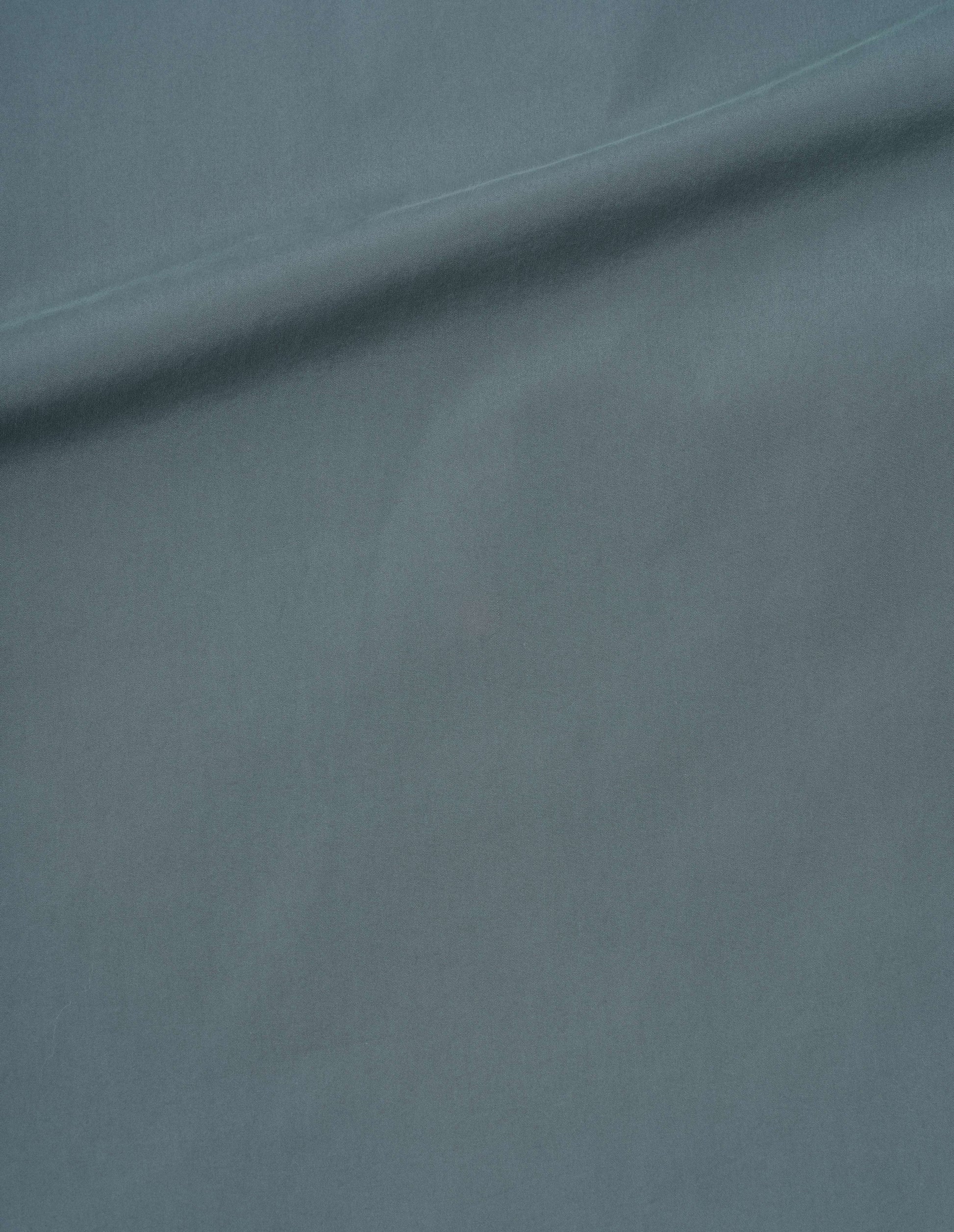 Blue compact washed cotton shirt fabric swatch.