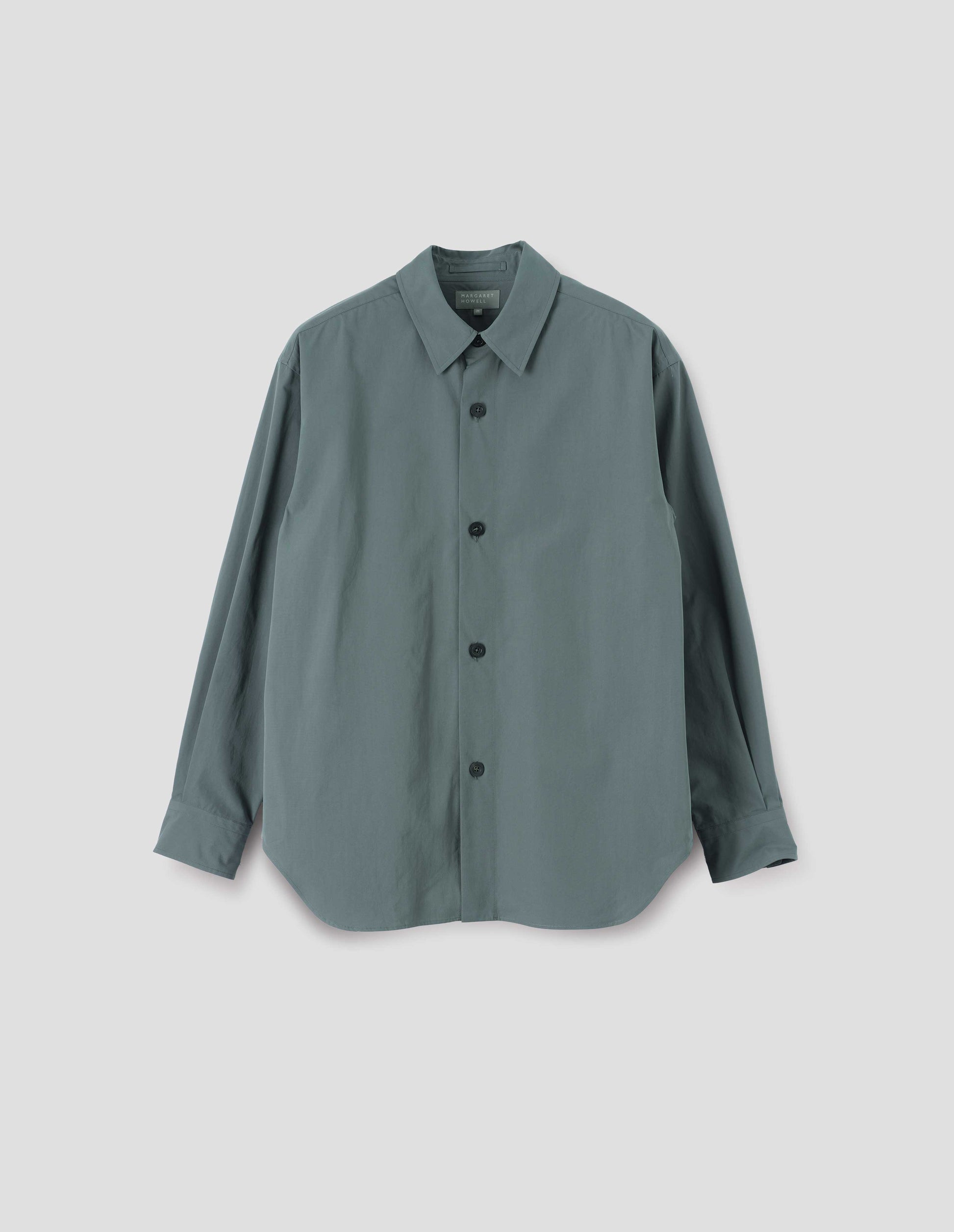 Blue shirt with stitch through placket and horn buttons. Front flat lay view.