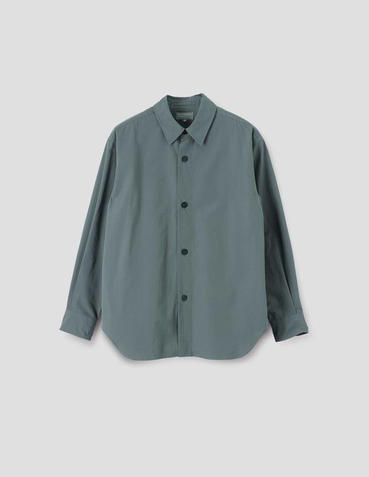 Blue shirt with stitch through placket and horn buttons. Front flat lay view.