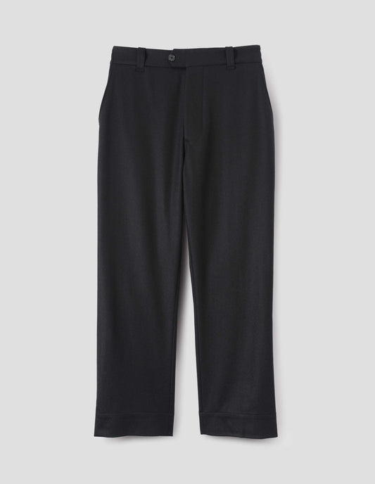 Navy blue wool trousers, with half elasticated waistband, belt loops, horn button tab fastening and slant pockets. Front flat lay view.