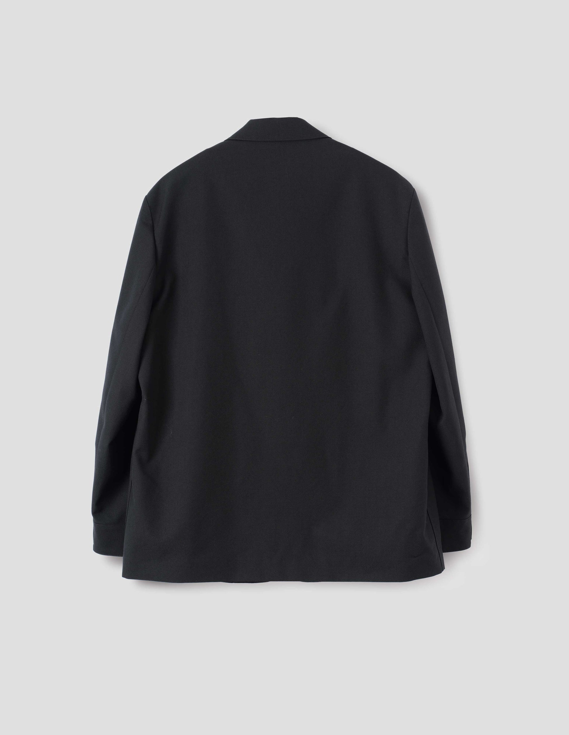 Black wool blazer with horn button shirt cuffs. Back flat lay view.