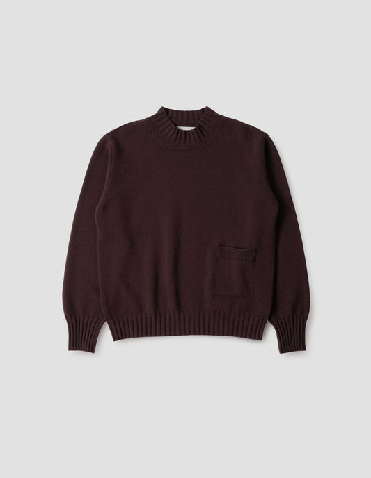 Dark brown ribbed crew neck jumper with ribbed cuffs and hem, and patch pocket with rib detail, front flat lay view.