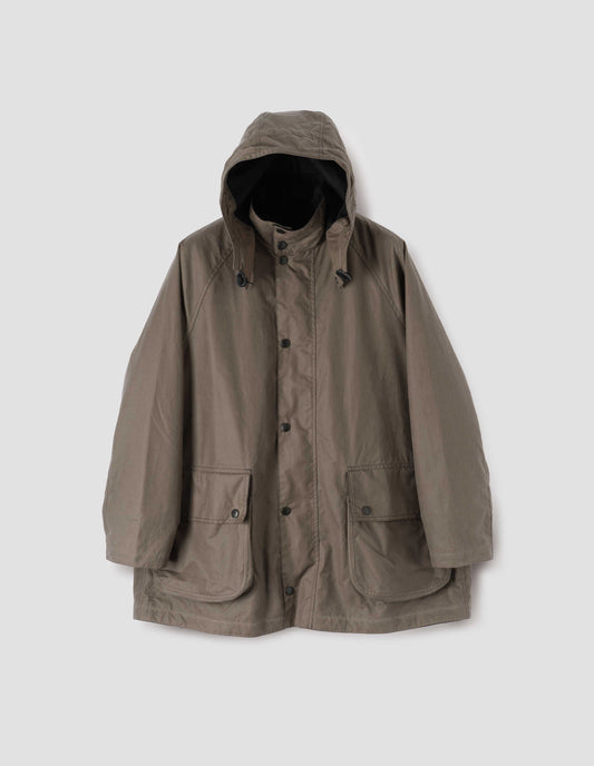 Dark beige parka with stand collar and hood with wire adjustable peak, raglan sleeve, press stud fastening storm flap and large bellows pockets with press stud fastening envelope closure. Front flat lay view.