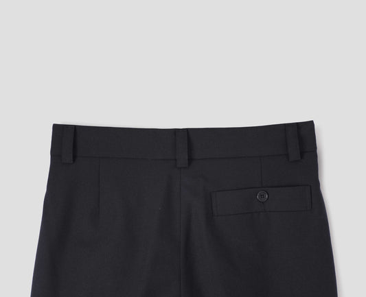 Black plainweave wool trousers with concealed side pockets, belt loops and deep button through welt back pocket. Back flat lay view. 