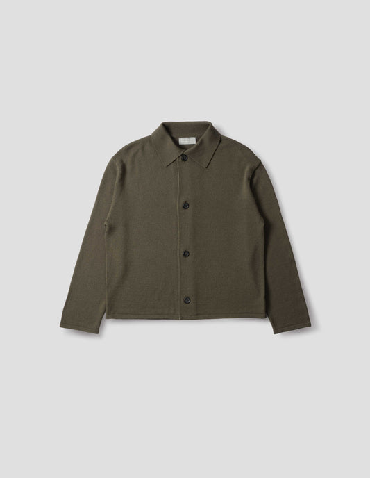 Green merino cardigan with jersey stitch, fully fashioned collar, horn button fastening, set-in fully fashioned sleeves, and tubular hem and cuffs. Front flat lay view.