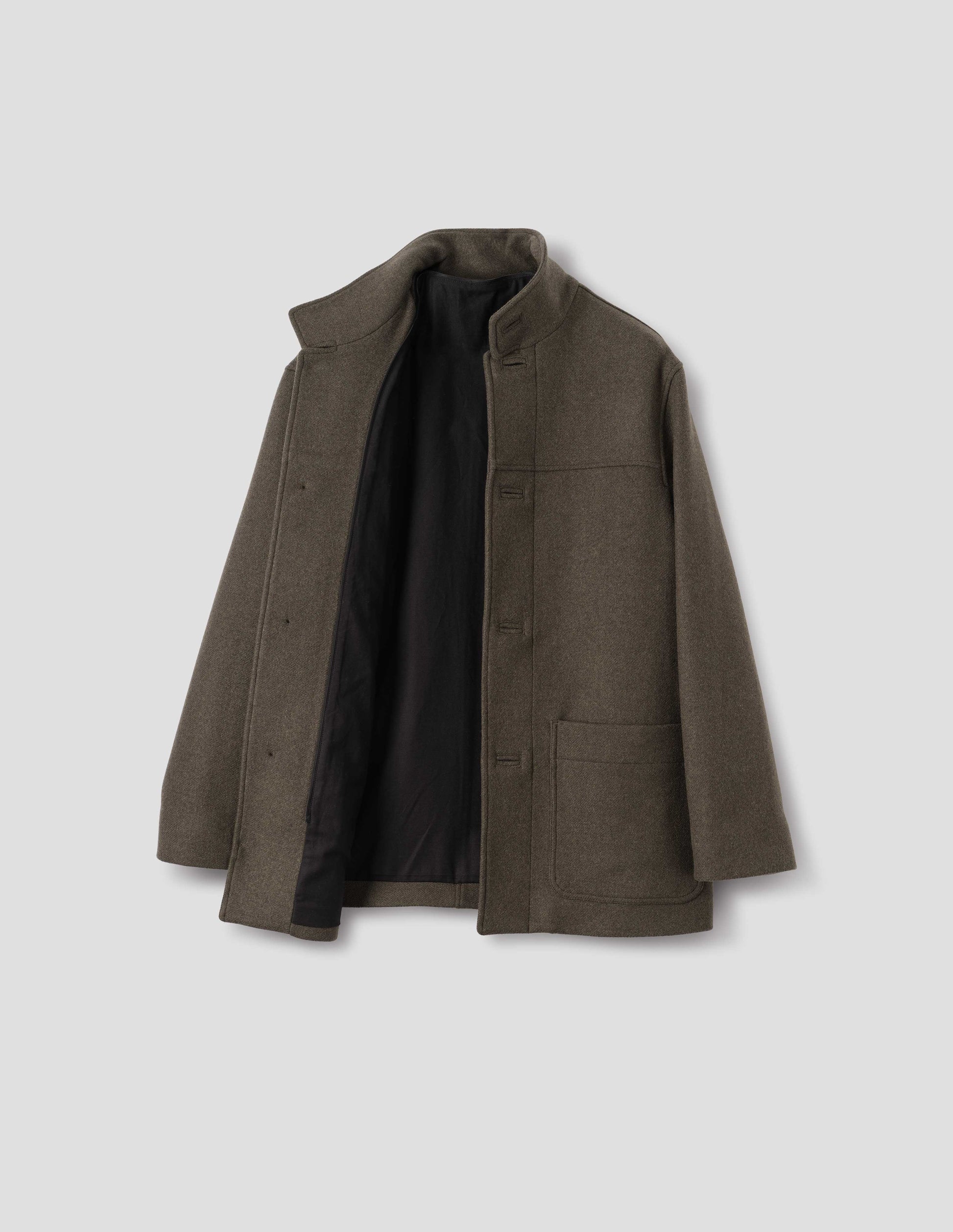 Khaki green wool coat with half mock collar, front yoke, jetted buttonholes and patch pockets. Open flat lay view.