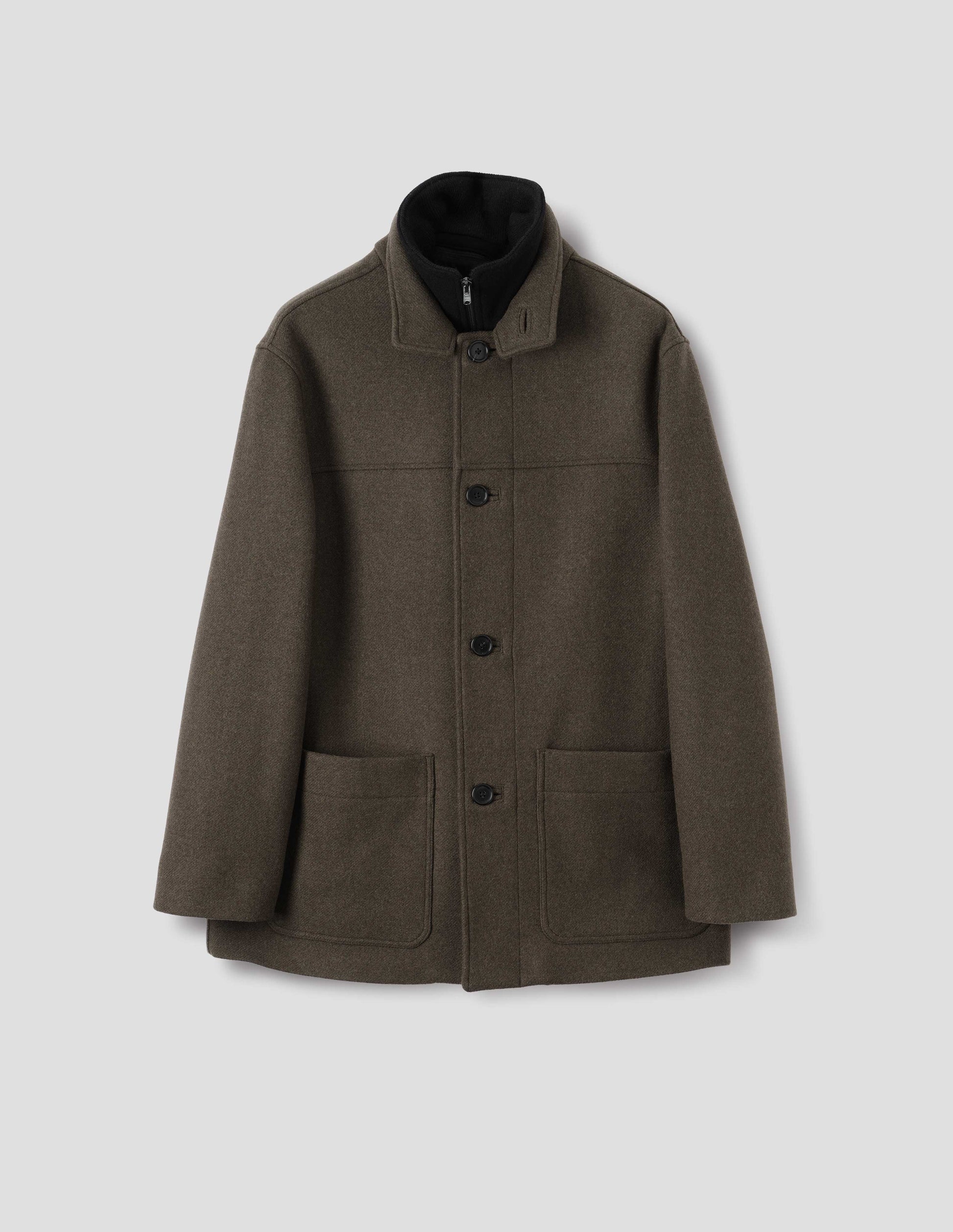 Khaki green wool coat with internal funnel collar with zip closure and external half mock collar, front yoke, horn buttons and jetted buttonholes, and patch pockets. Front flat lay view.