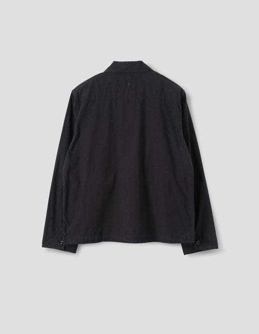 Black cotton shirt, with stitched through back yoke and buttoned cuffs, back flat lay view.