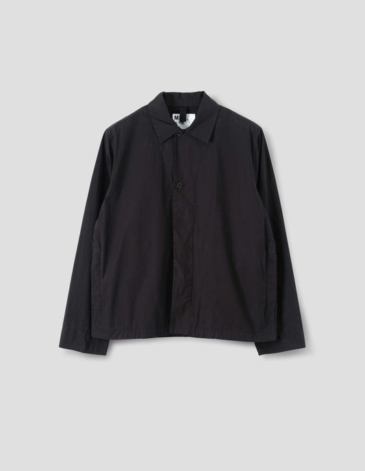 Black cotton shirt, with top two dark buttons exposed and side seam welt pockets, front flat lay view.