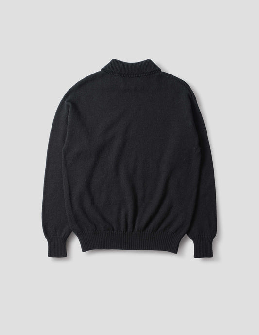 Collared wool sweater in black with a wide rib linked on collar, plain knit body, and deeper ribbed cuffs. Finished with a straight hem, back flat view.