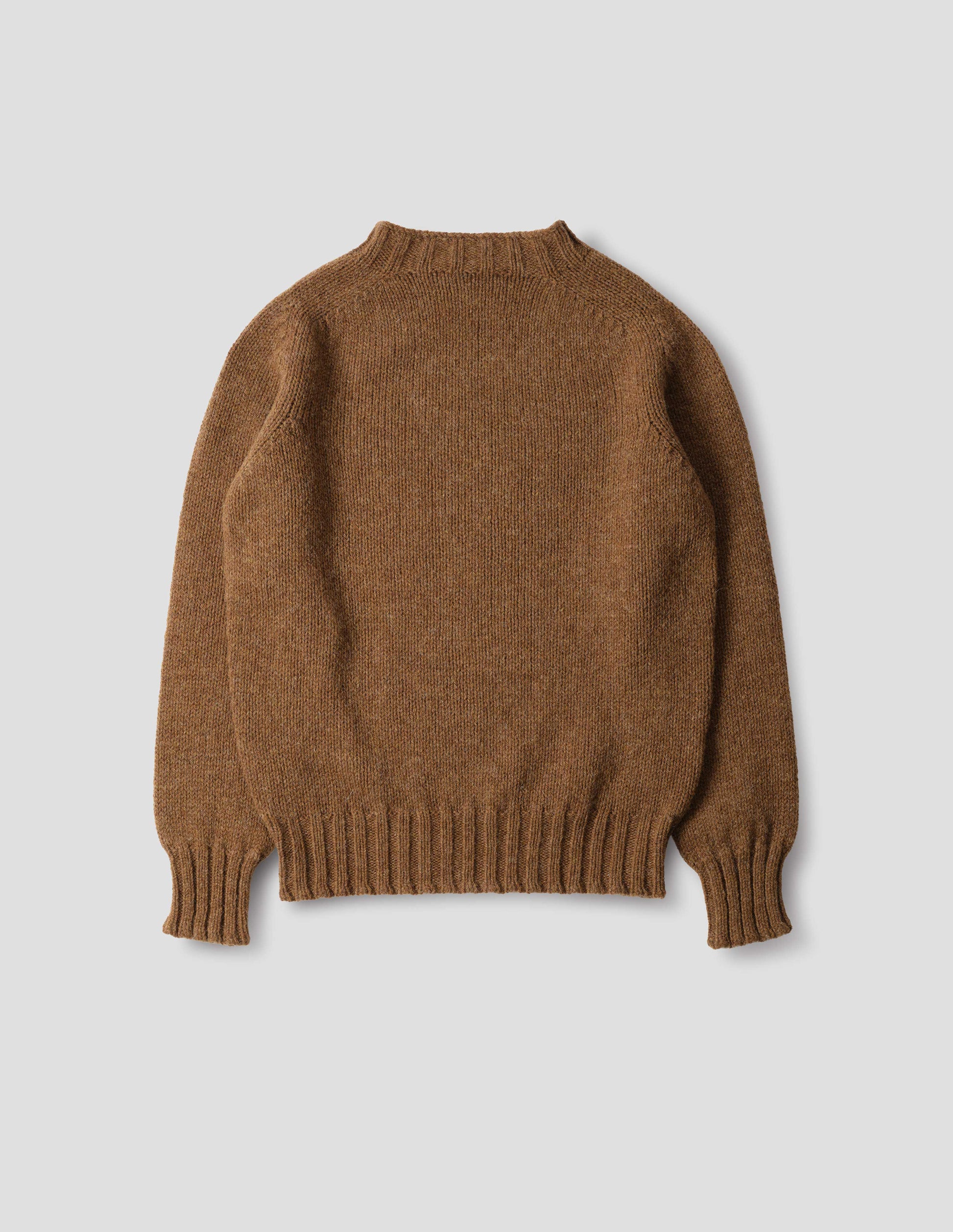 Orangey brown long sleeve wool jumper, with contrast ribbing on neckline, cuffs and hem. Back flat lay view.