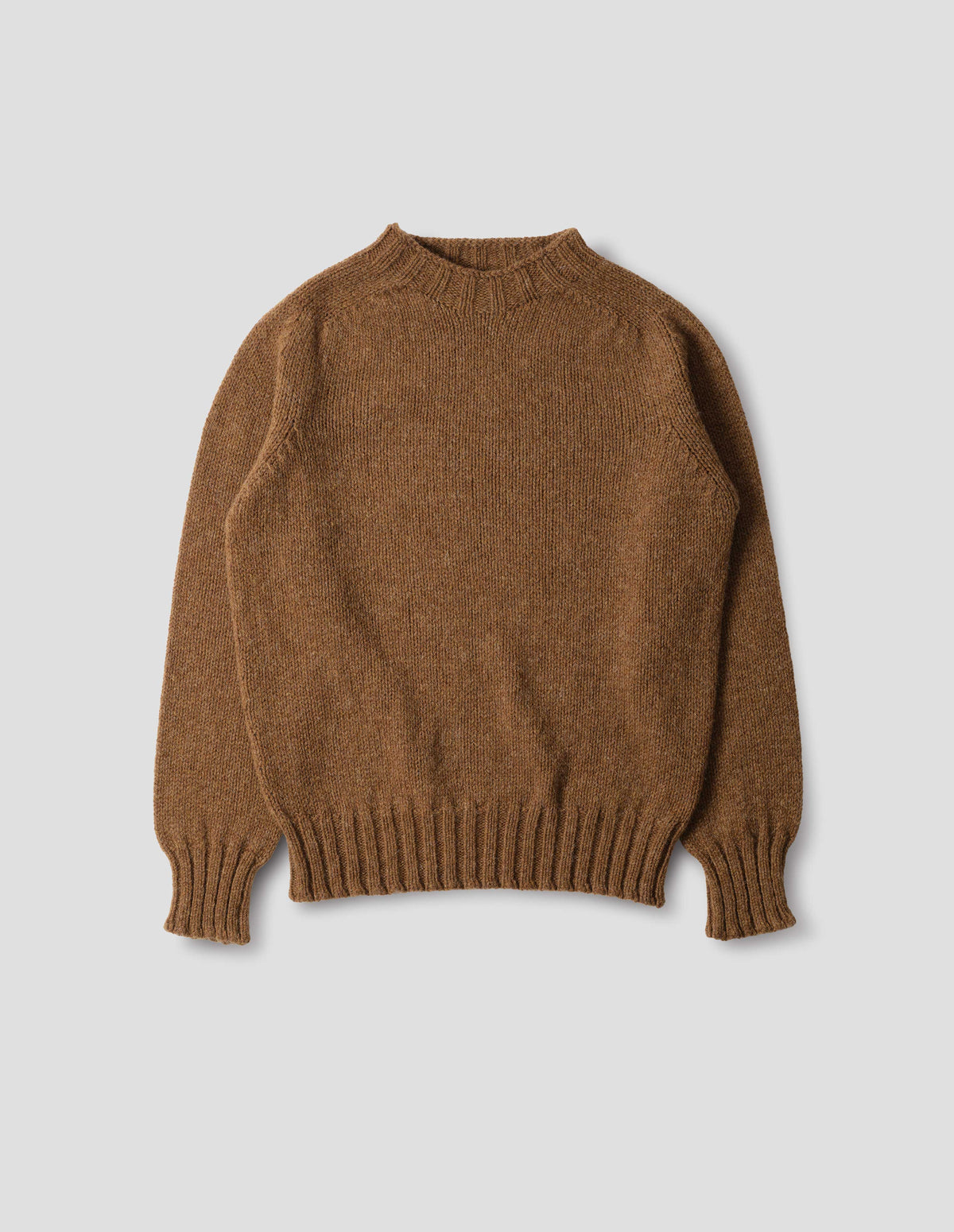 Orangey brown long sleeve wool jumper, with contrast ribbing on neckline, cuffs and hem. Front flat lay view.