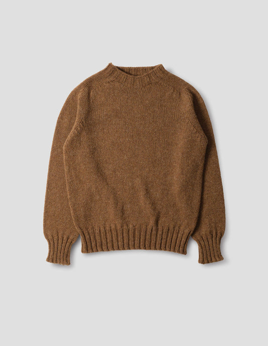 Orangey brown long sleeve wool jumper, with contrast ribbing on neckline, cuffs and hem. Front flat lay view.