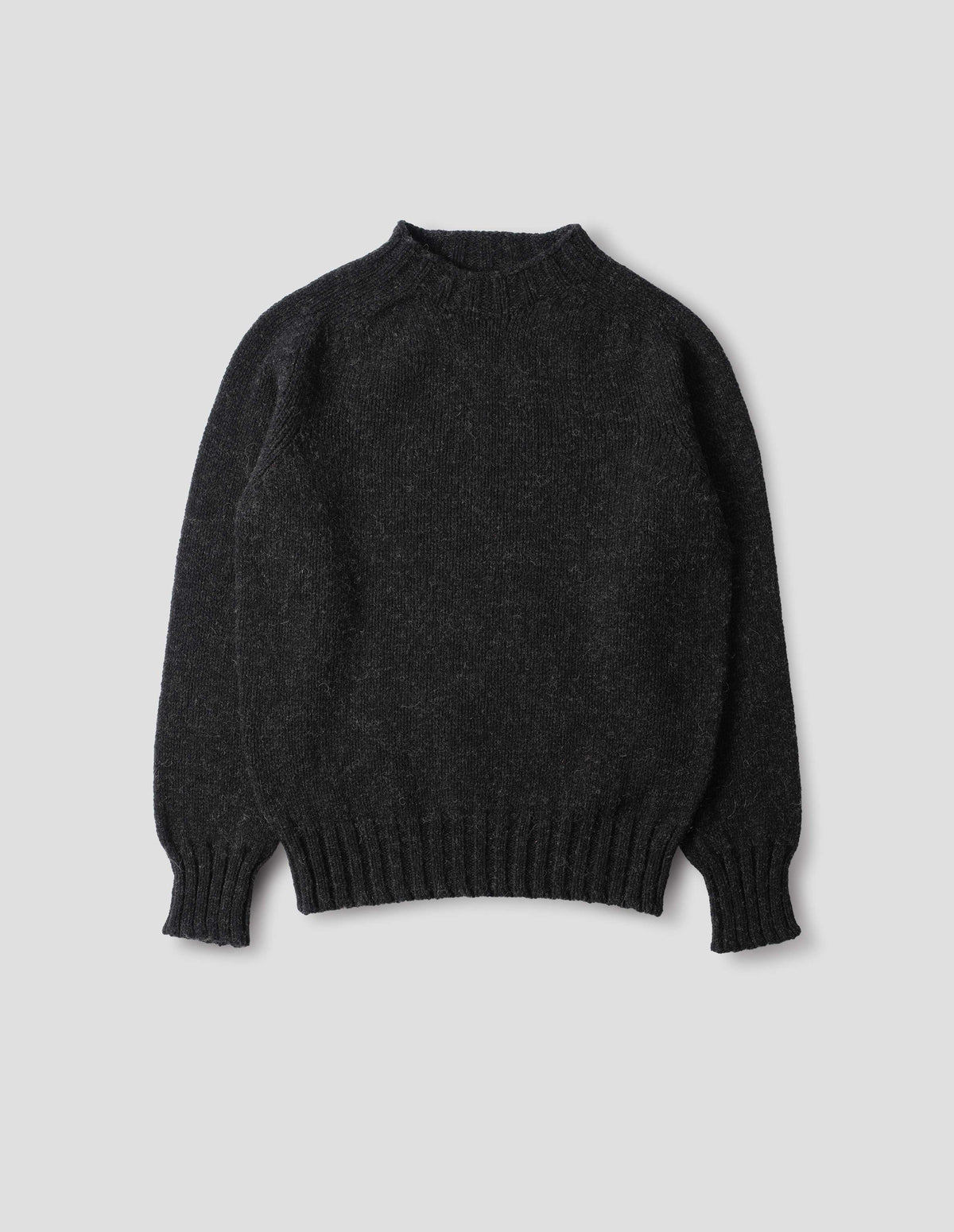 Dark grey long sleeve wool jumper, with contrast ribbing on neckline, cuffs and hem. Front flat lay view.