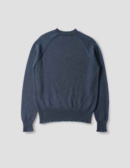 Blue wool jumper, with raglan sleeve, rib collar, cuffs and hem, back flat lay view.