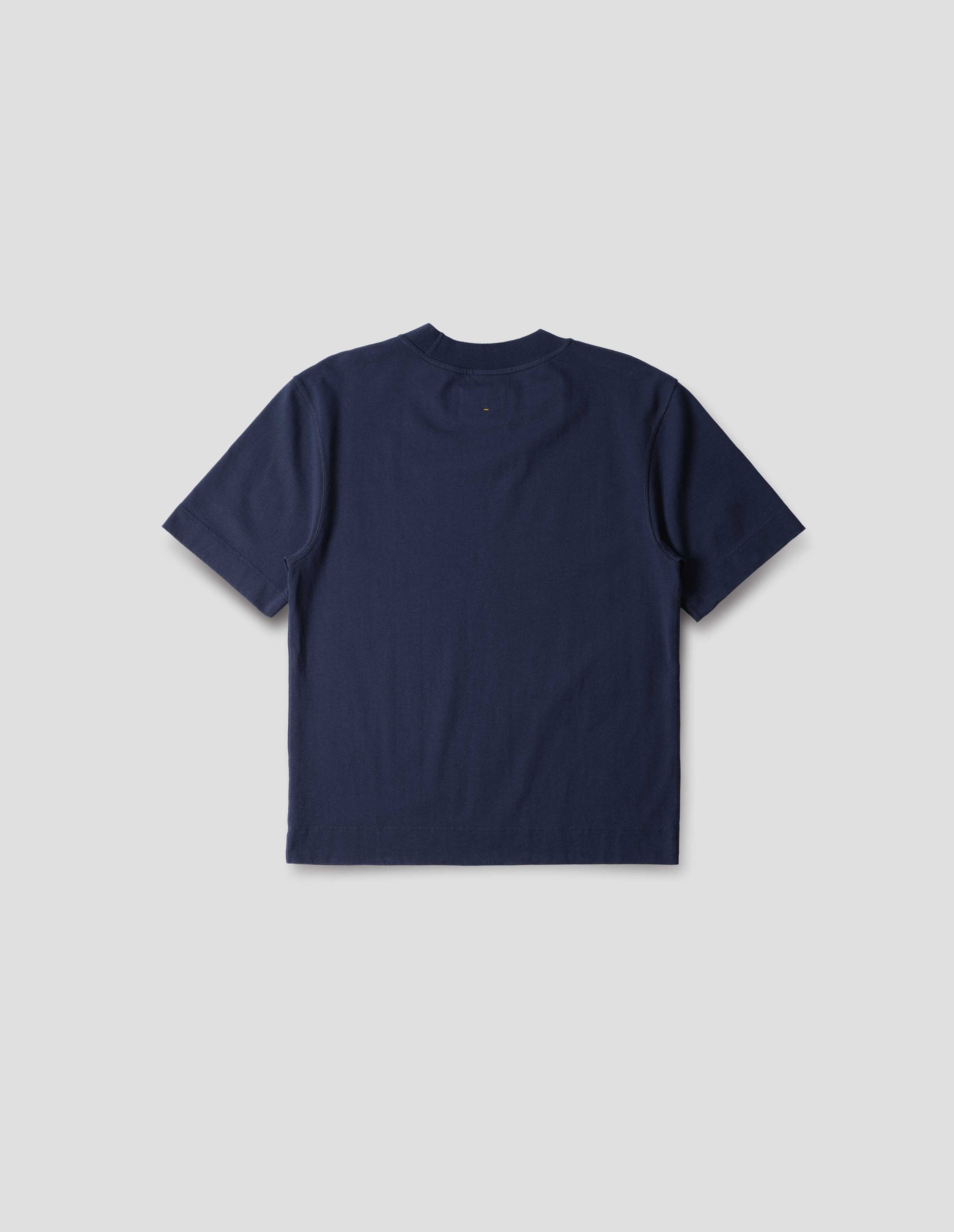 Blue cotton t shirt, with ribbed neck and flatlock stitching, back flat lay view.