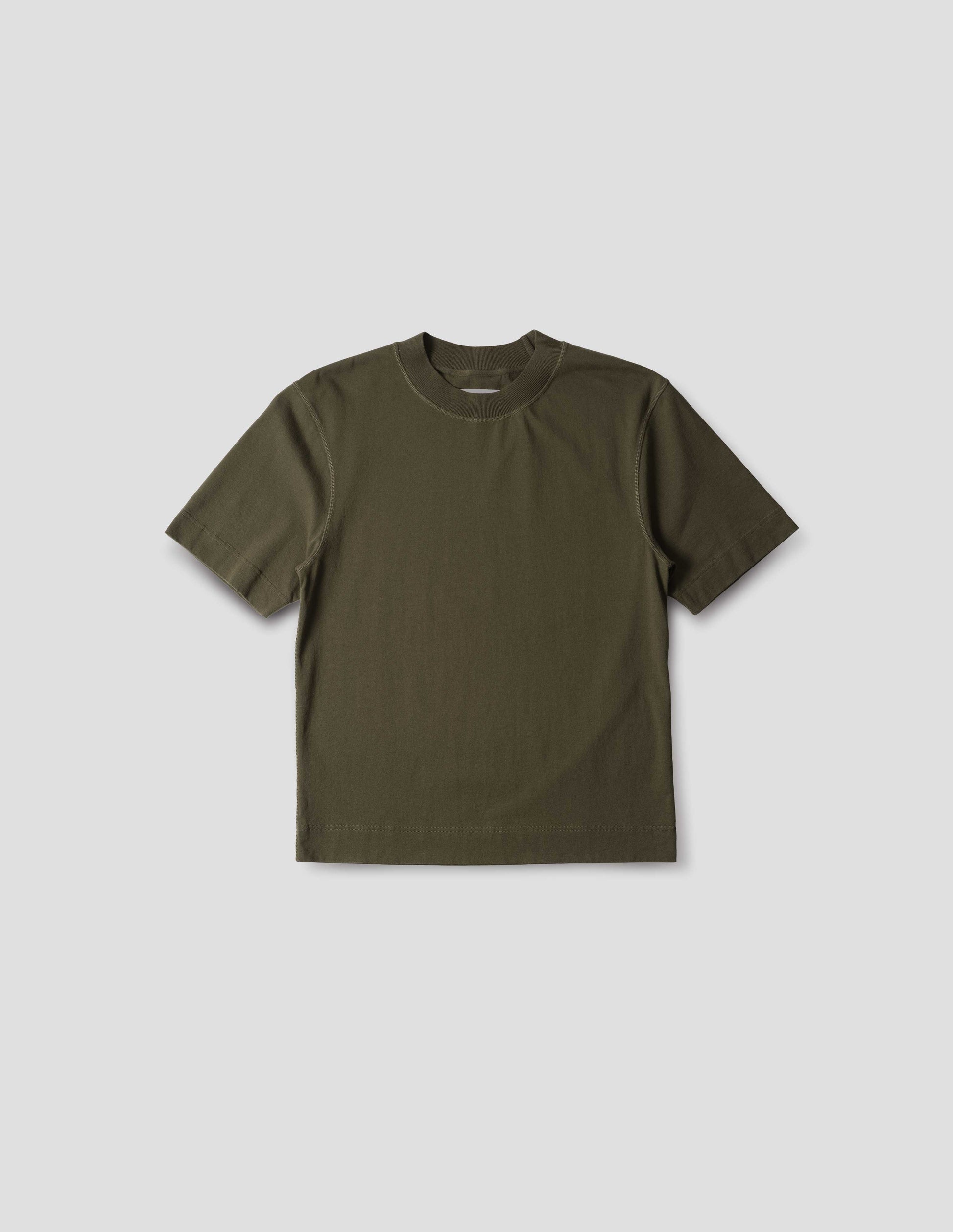Green flatlock crew short sleeve T shirt, features a rib neck and flatlock stitch detailing on the seams, front flat lay view.