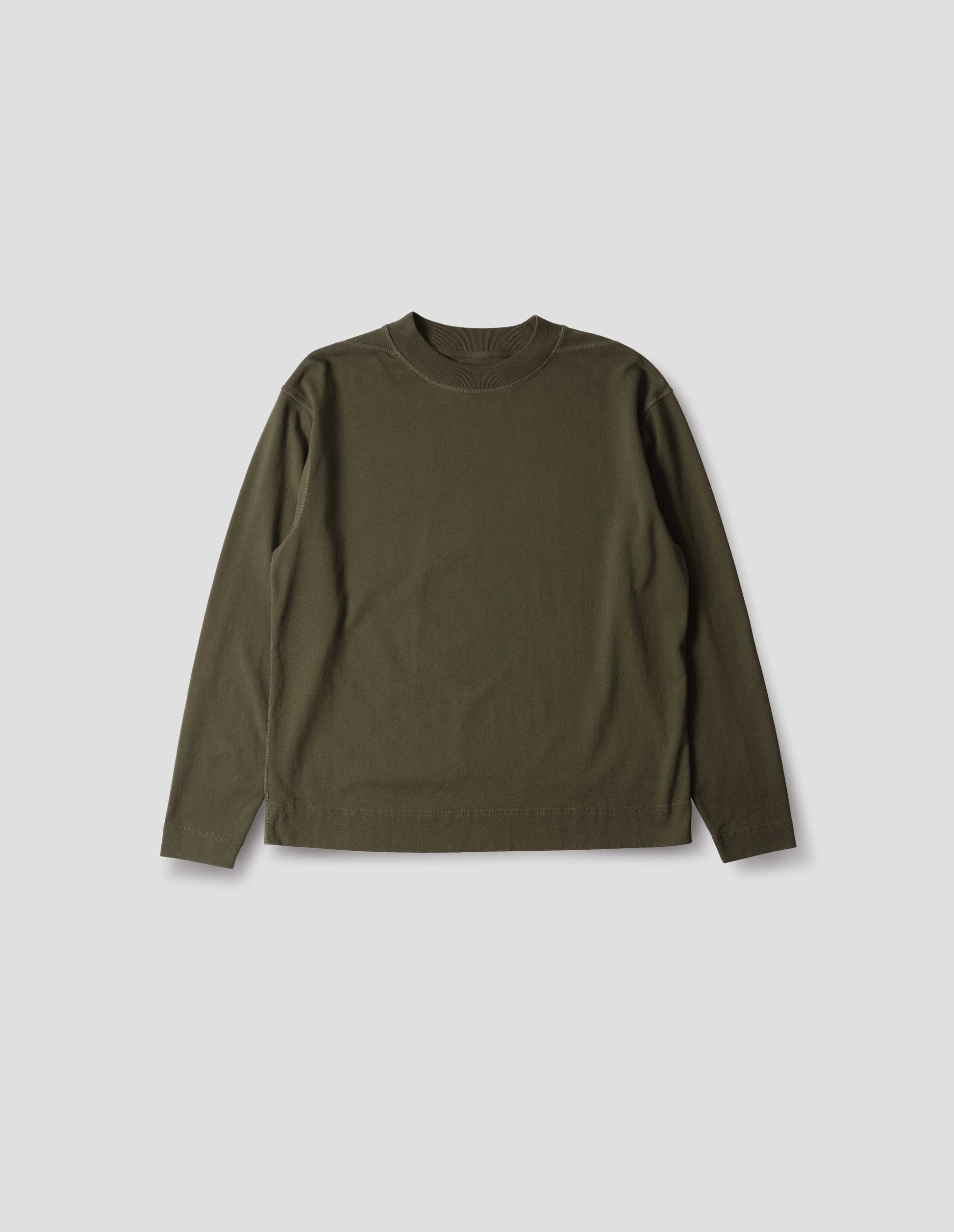 Brownish green cotton t shirt, with long sleeves, flatlock stitching, a deep ribbed collar and ribbed triangle insert on the shoulder, front flat lay view.