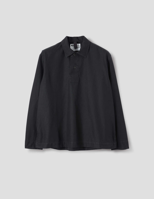 Black denim shirt, with wide front placket, two button closure, split placket, and straight side split hem. Front flat lay view.