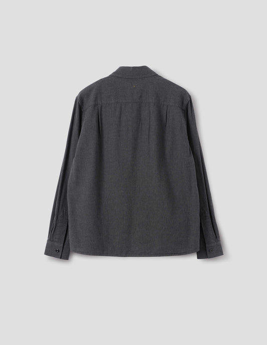 Dark grey cotton chambray shirt with a dropped shoulder and pleats on back yoke, back flat lay view.