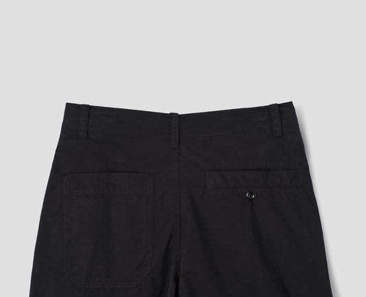 Black cotton trousers, with  two welt back pockets, one is button-through, back flat lay view.