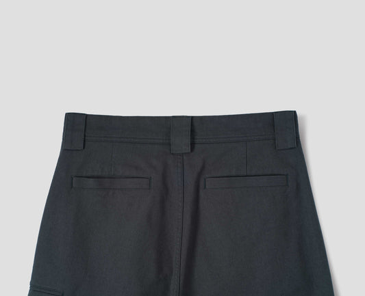 Blueish grey cotton trousers, with wide belt loops and welt pockets at the back. Back flat lay view.