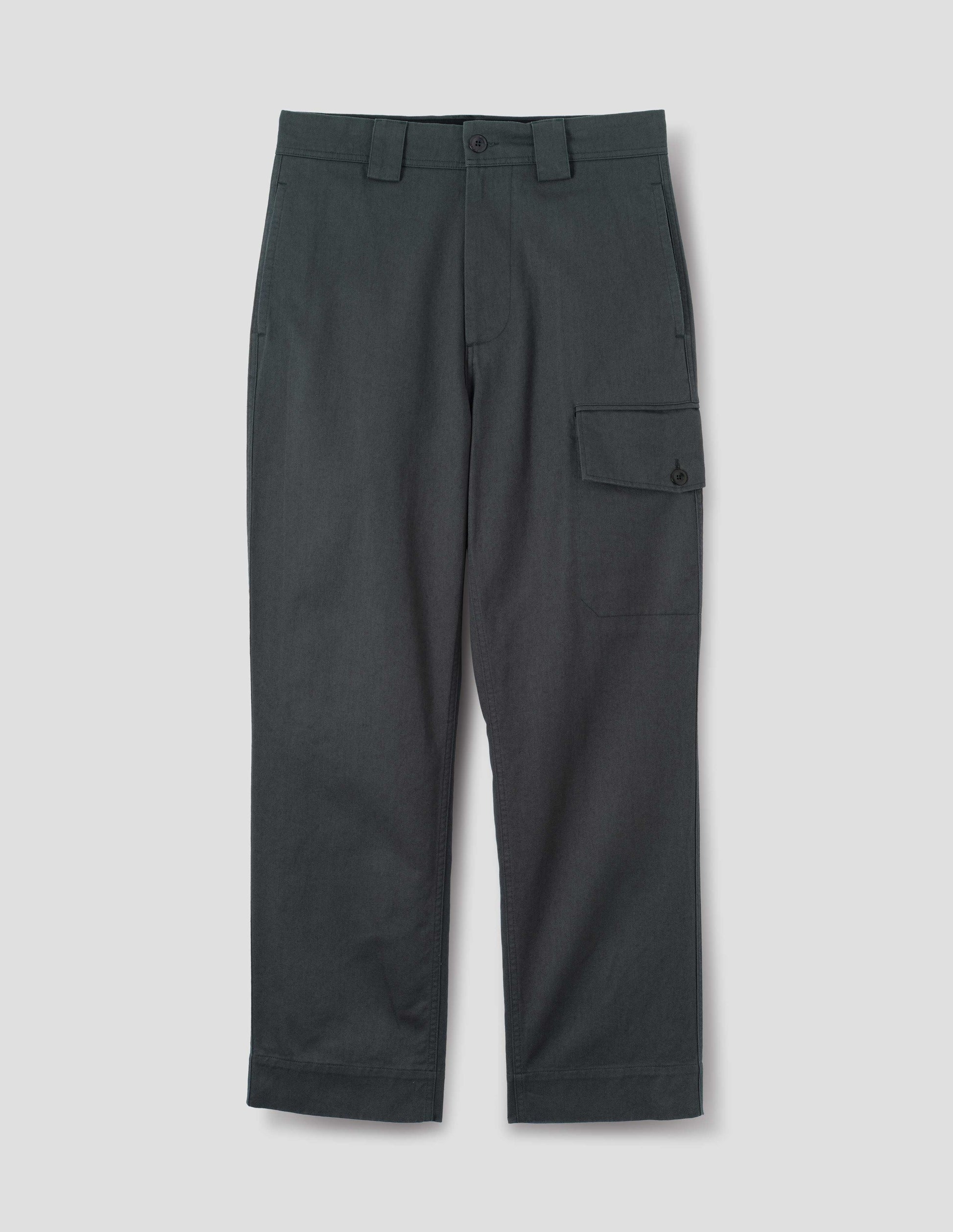 Blueish grey cotton trousers, with wide belt loops and a button and zip fly fastening. With side seam pockets, a large cargo pocket with button fastening. Front flat lay view.