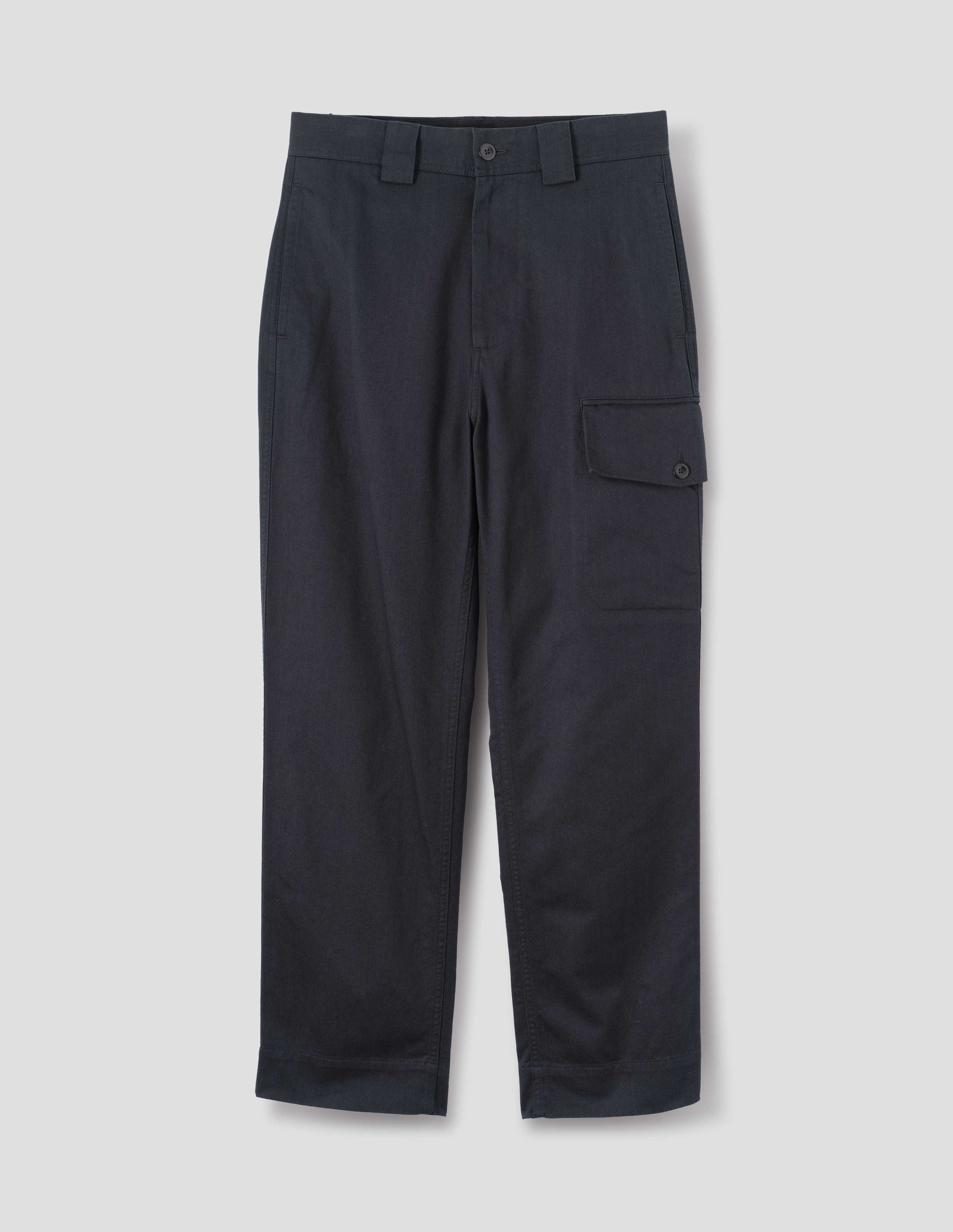 Dark blue cotton trousers, with wide belt loops and a dark button with a large cargo pocket with pocket bag and button fastening, front flat lay view.