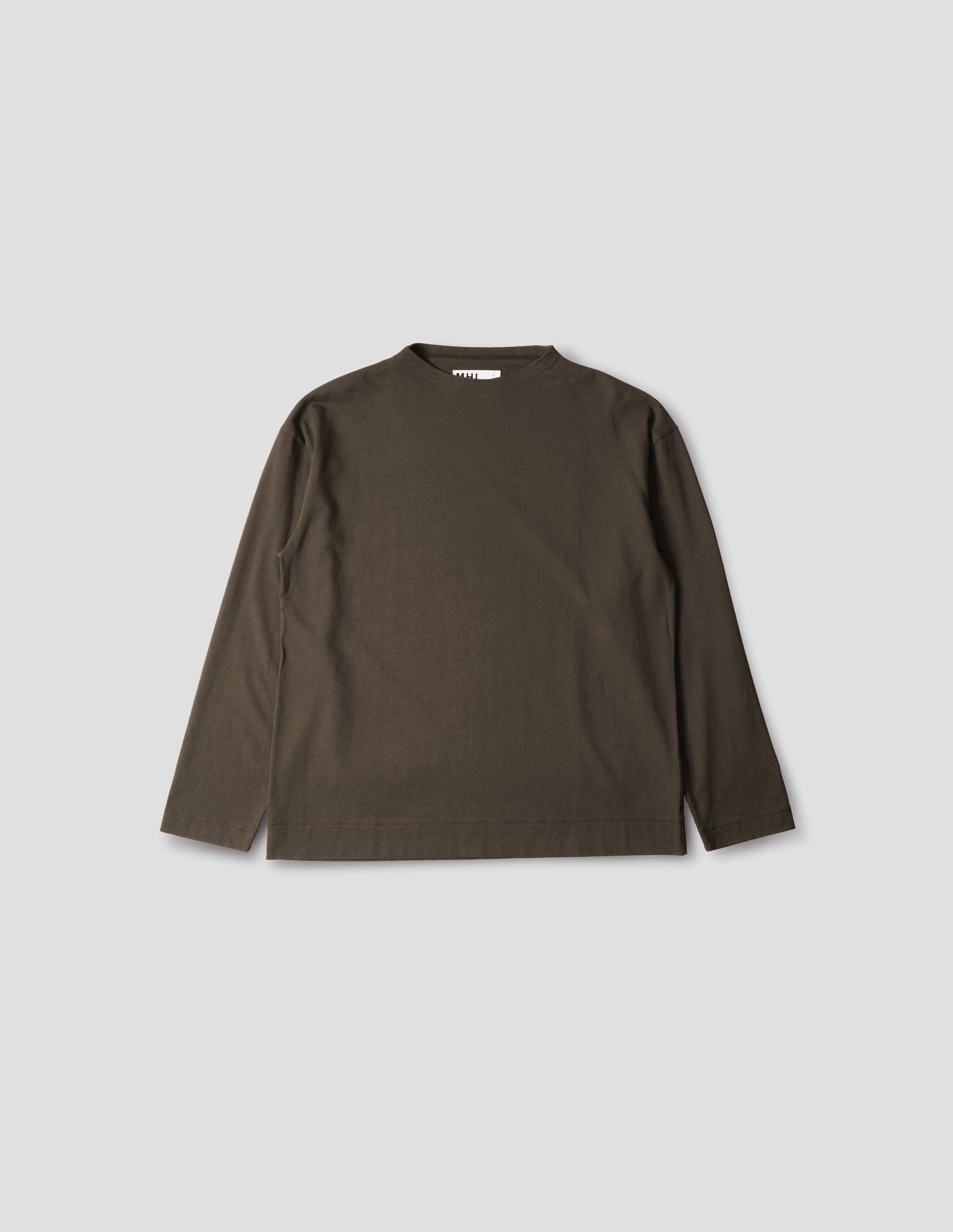 Brown cotton t shirt, with long sleeves and flatlock stitching around cuffs and hem, front flat lay view.