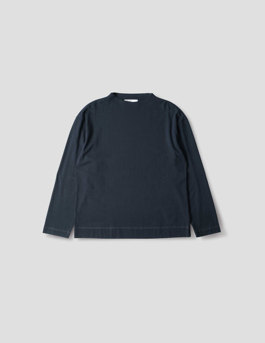 Dark blue cotton t shirt, with long sleeves and flatlock stitching around cuffs and hem, front flat lay view.