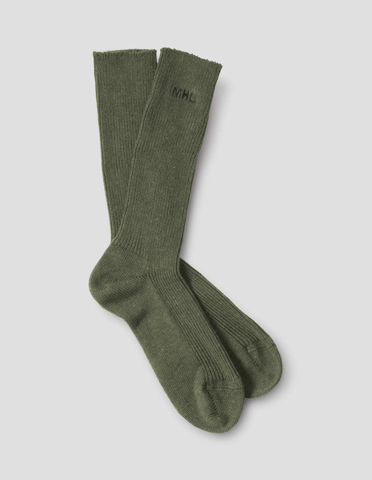Green cotton socks, with embroidered MHL logo, front flat lay view.