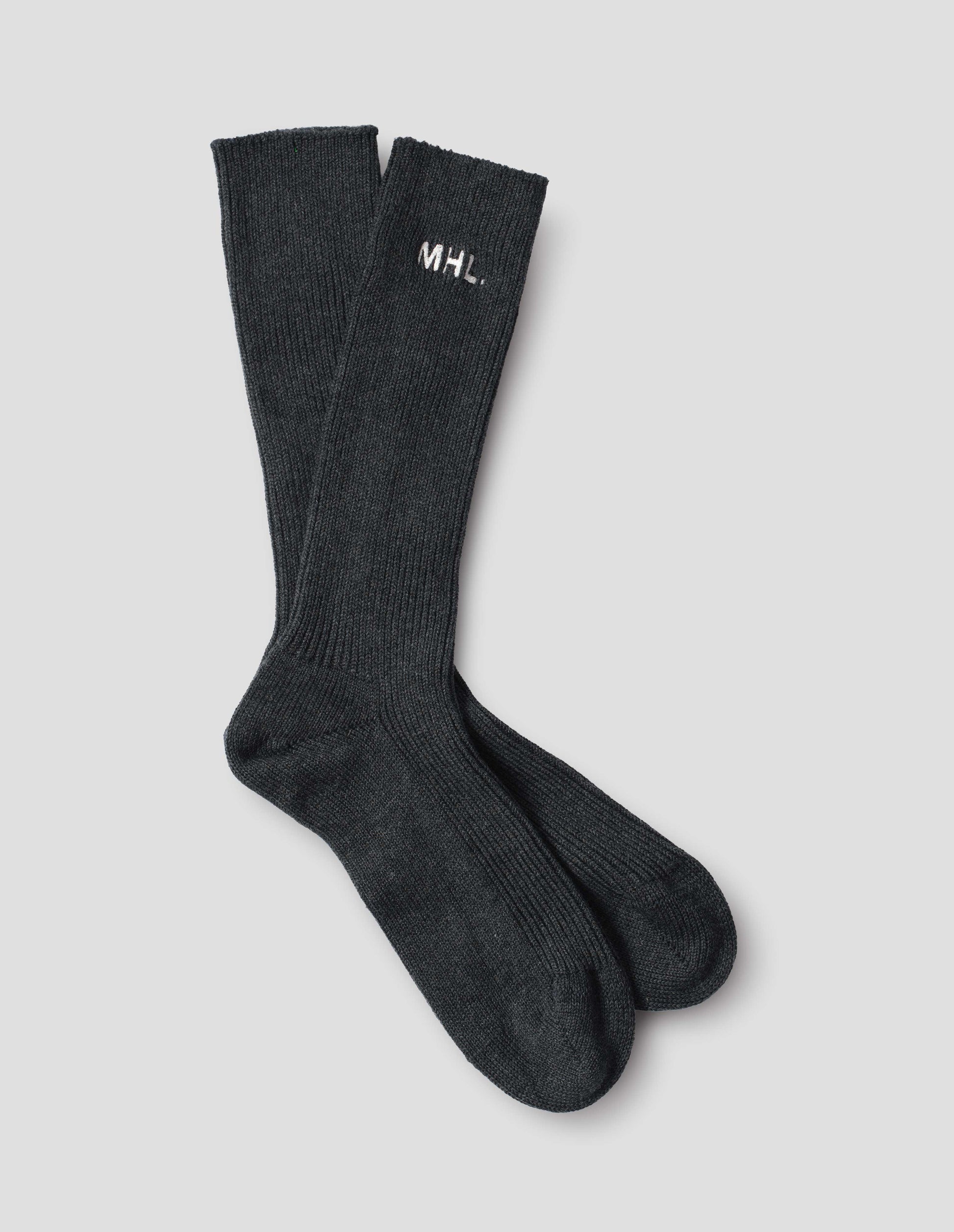 Dark grey cotton socks, with embroidered MHL logo, front flat lay view.